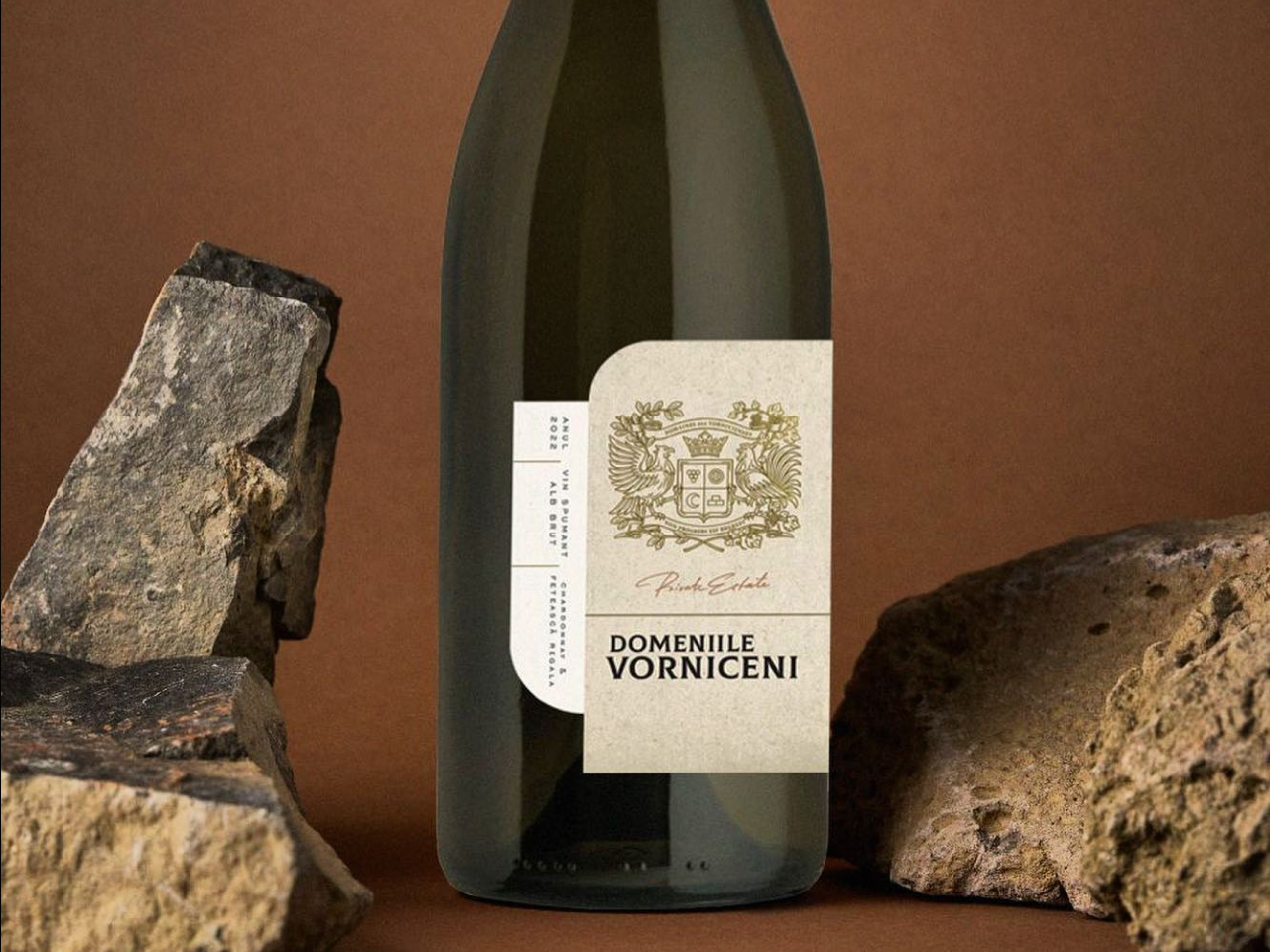 A bottle of sparkling wine Domeniile Vorniceni, on the brown background with rocks on sides